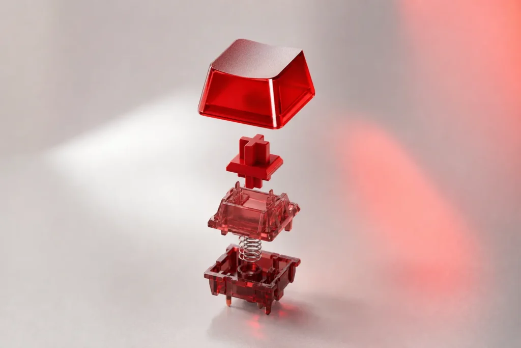 Tecla de teclado roja translúcida desmontada en piezas flotantes